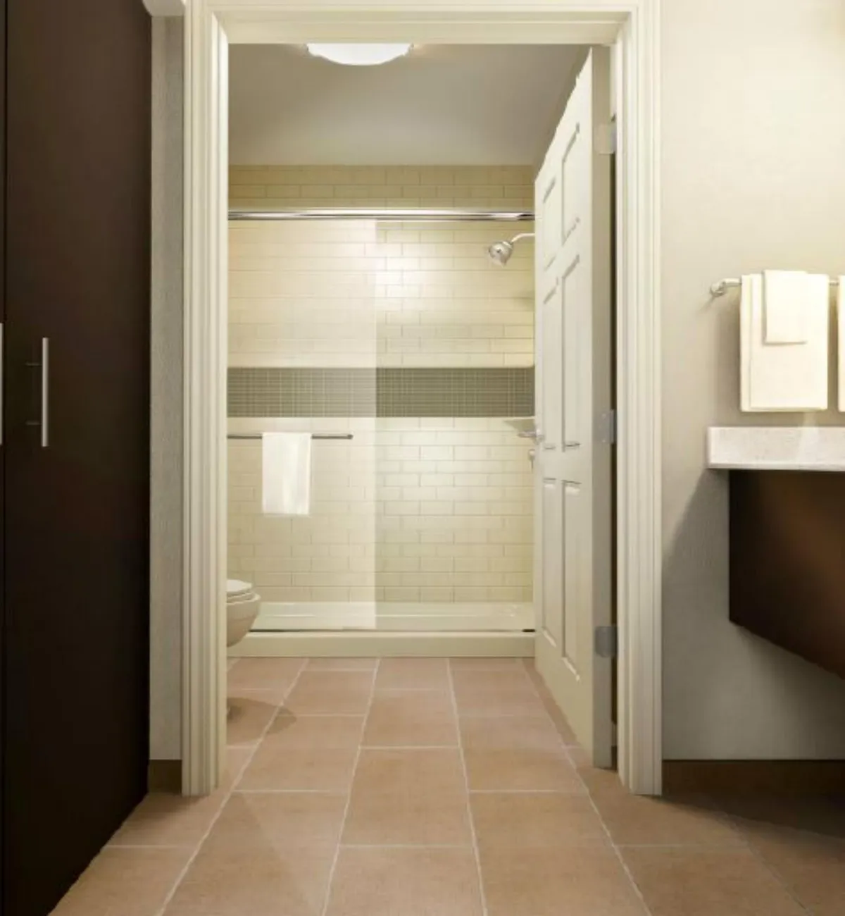 A serene bathroom scene featuring a spacious shower area, a sink neatly arranged with fluffy towels, and a door providing privacy. The space feels accessible, bright, and inviting, suggesting comfort and ease for guests needing restful surroundings.